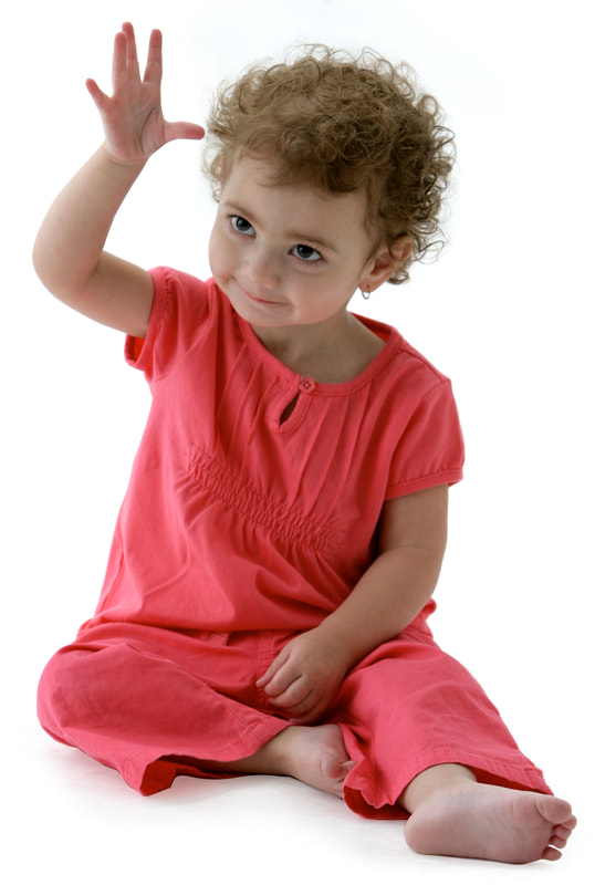 photo of young child doing hand signs