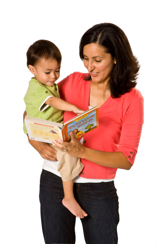 photo of young child and adult woman reading "Playtime Signs" book